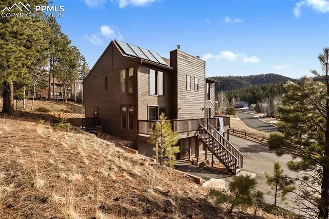 a view of a house with wooden fence