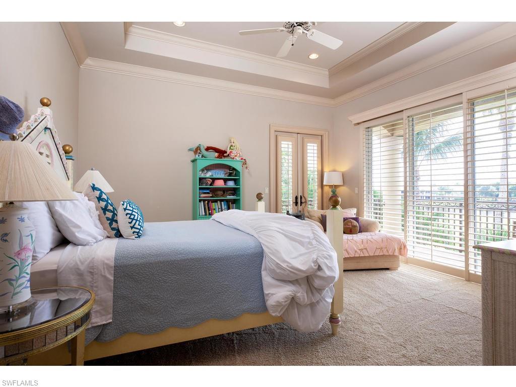 8631 Blue Flag Way Naples, FL 34109 - Photo 12 of 18 a bedroom with a bed and a large window