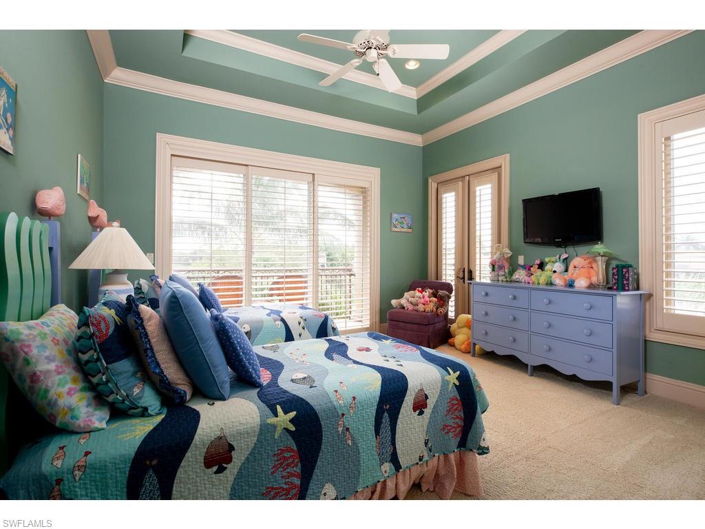 8631 Blue Flag Way Naples, FL 34109 - Photo 13 of 18 a bed room with furniture and a flat screen tv