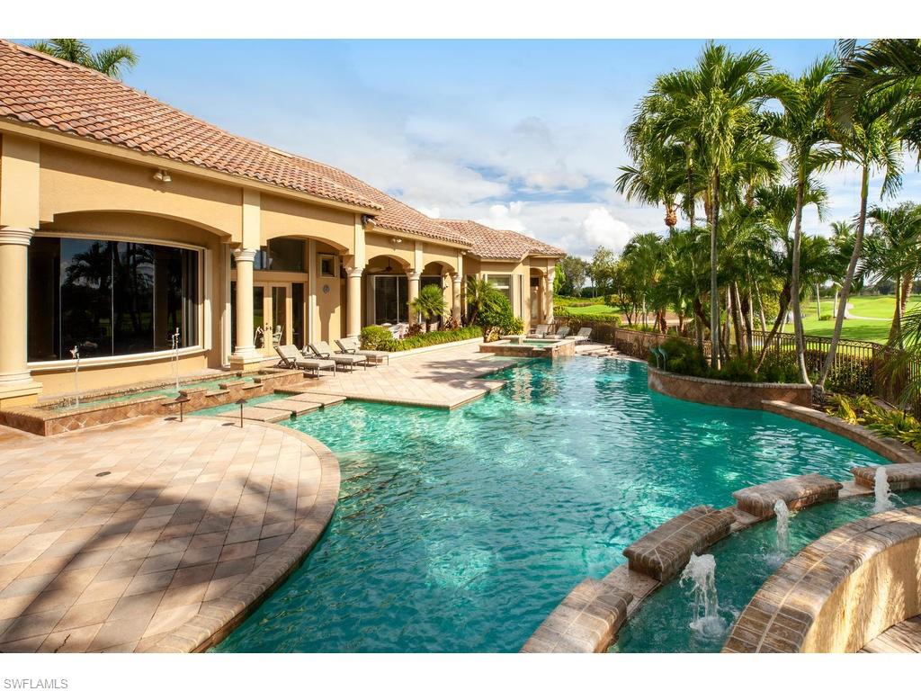 8631 Blue Flag Way Naples, FL 34109 - Photo 15 of 18 a backyard of a house with table and chairs potted plants and palm trees
