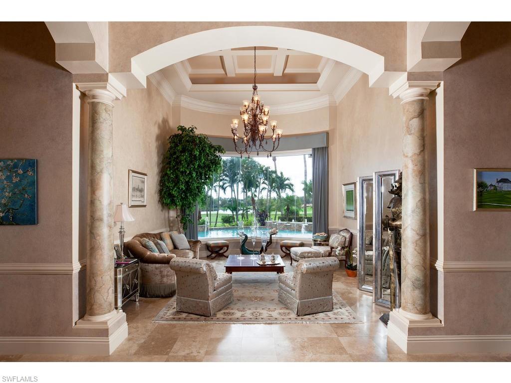 8631 Blue Flag Way Naples, FL 34109 - Photo 2 of 18 a living room with furniture and a chandelier