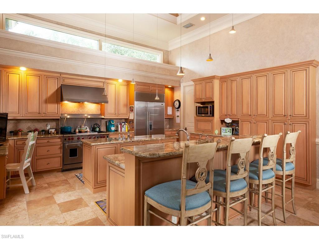 8631 Blue Flag Way Naples, FL 34109 - Photo 7 of 18 a kitchen with appliances a sink and cabinets