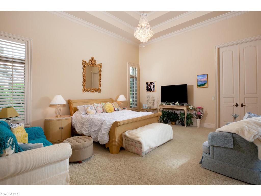 8631 Blue Flag Way Naples, FL 34109 - Photo 9 of 18 a bedroom with bed and a flat screen tv