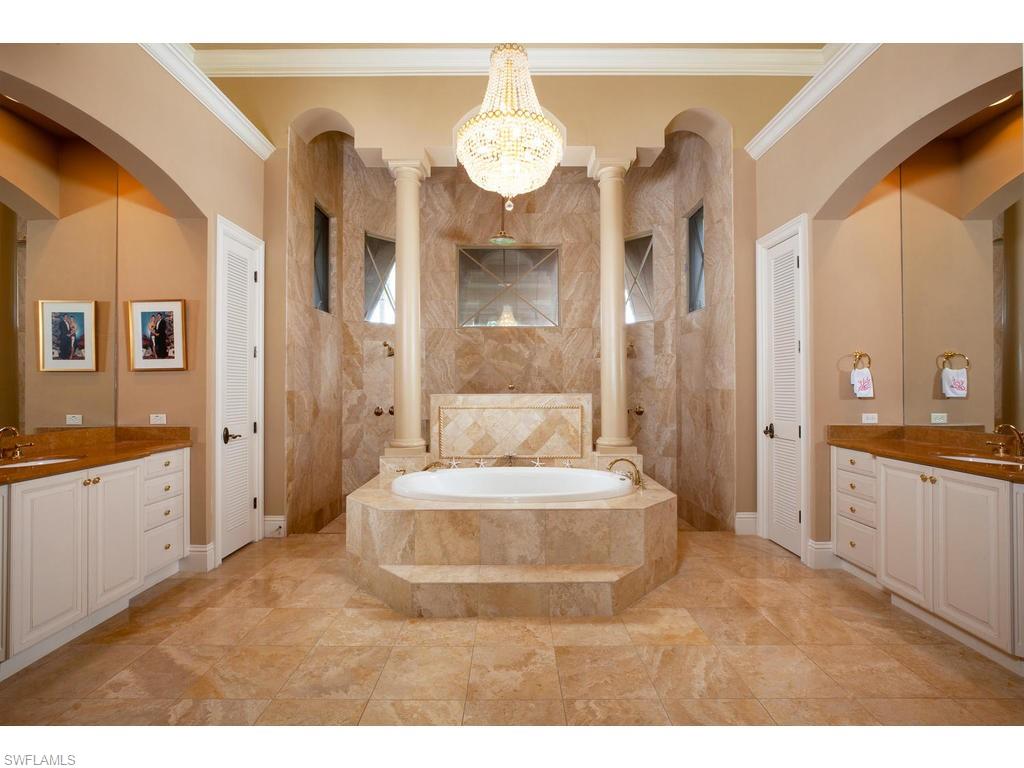 8631 Blue Flag Way Naples, FL 34109 - Photo 10 of 18 a spacious bathroom with a sink mirror and a bathtub