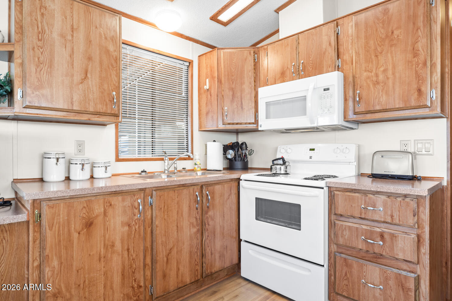 17200 West Bell Road, Unit 652 Surprise, AZ 85374 - Photo 13 of 19 a kitchen with granite countertop a sink stainless steel appliances and cabinets