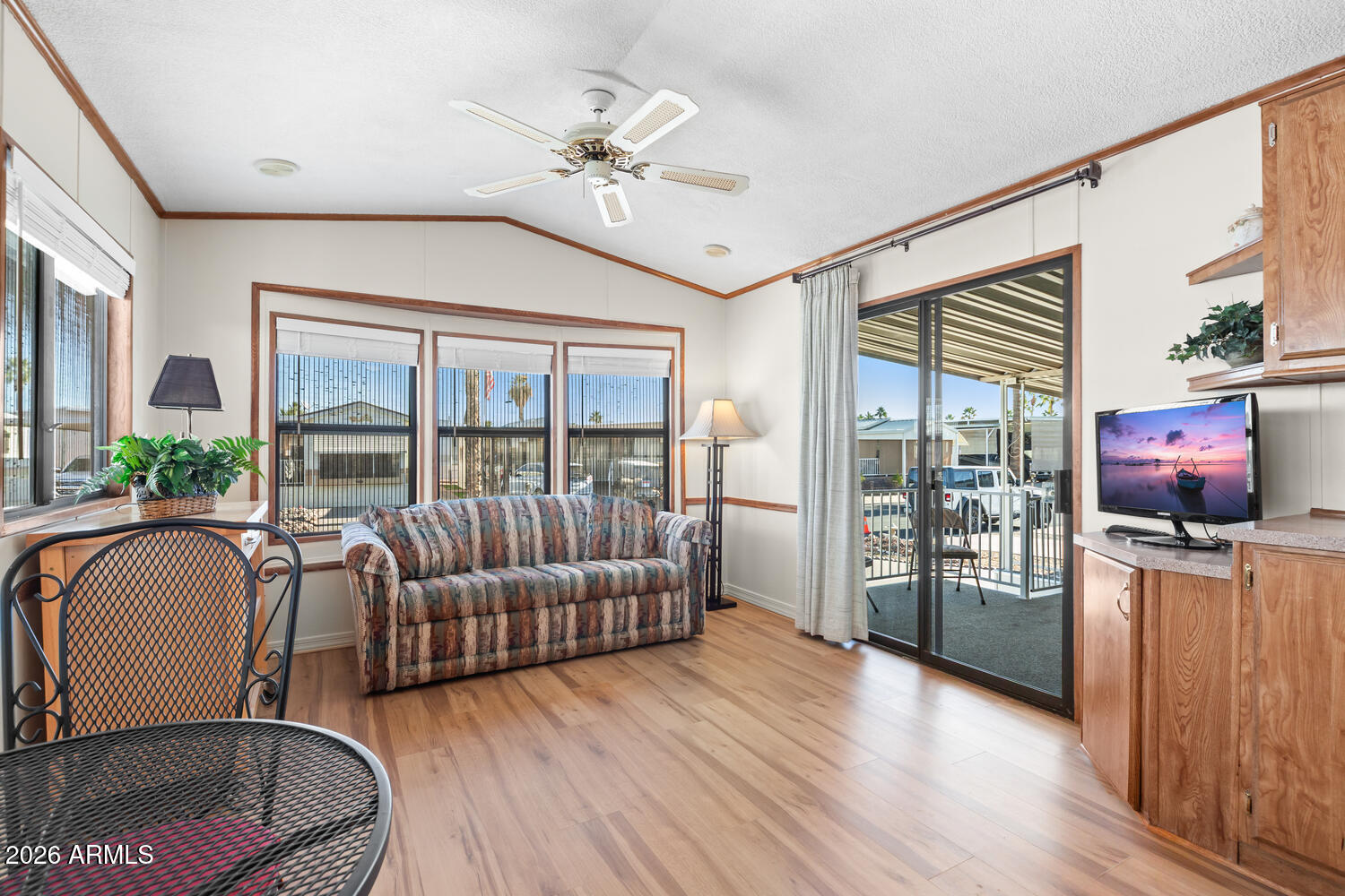 17200 West Bell Road, Unit 652 Surprise, AZ 85374 - Photo 2 of 19 a living room with furniture and a flat screen tv