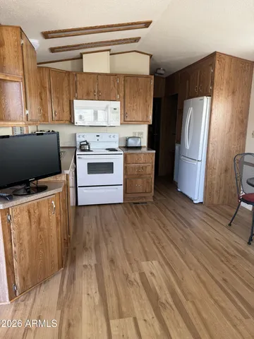 a kitchen with stainless steel appliances a refrigerator and a stove top oven