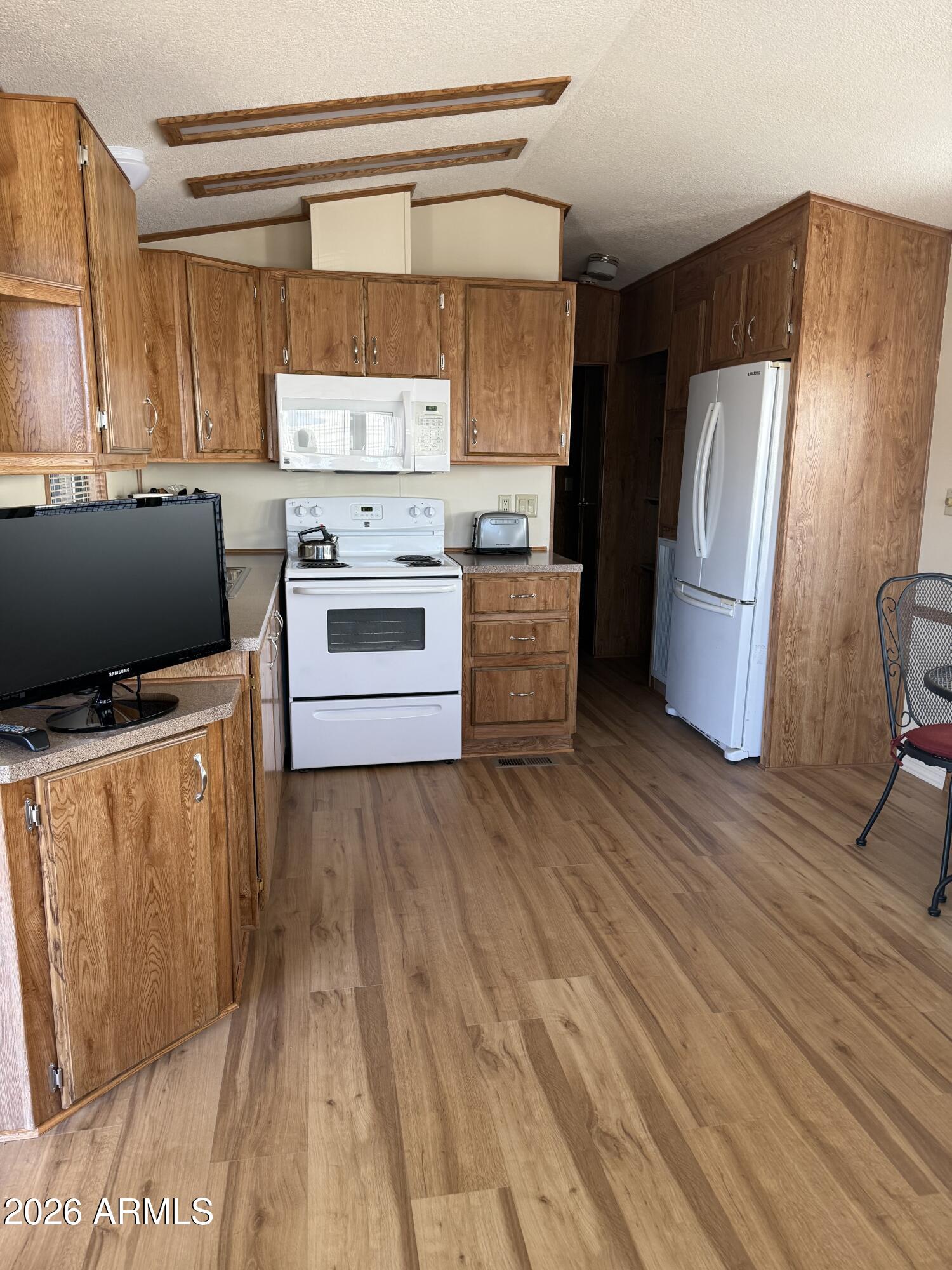 17200 West Bell Road, Unit 652 Surprise, AZ 85374 - Photo 3 of 5 a kitchen with stainless steel appliances a refrigerator and a stove top oven