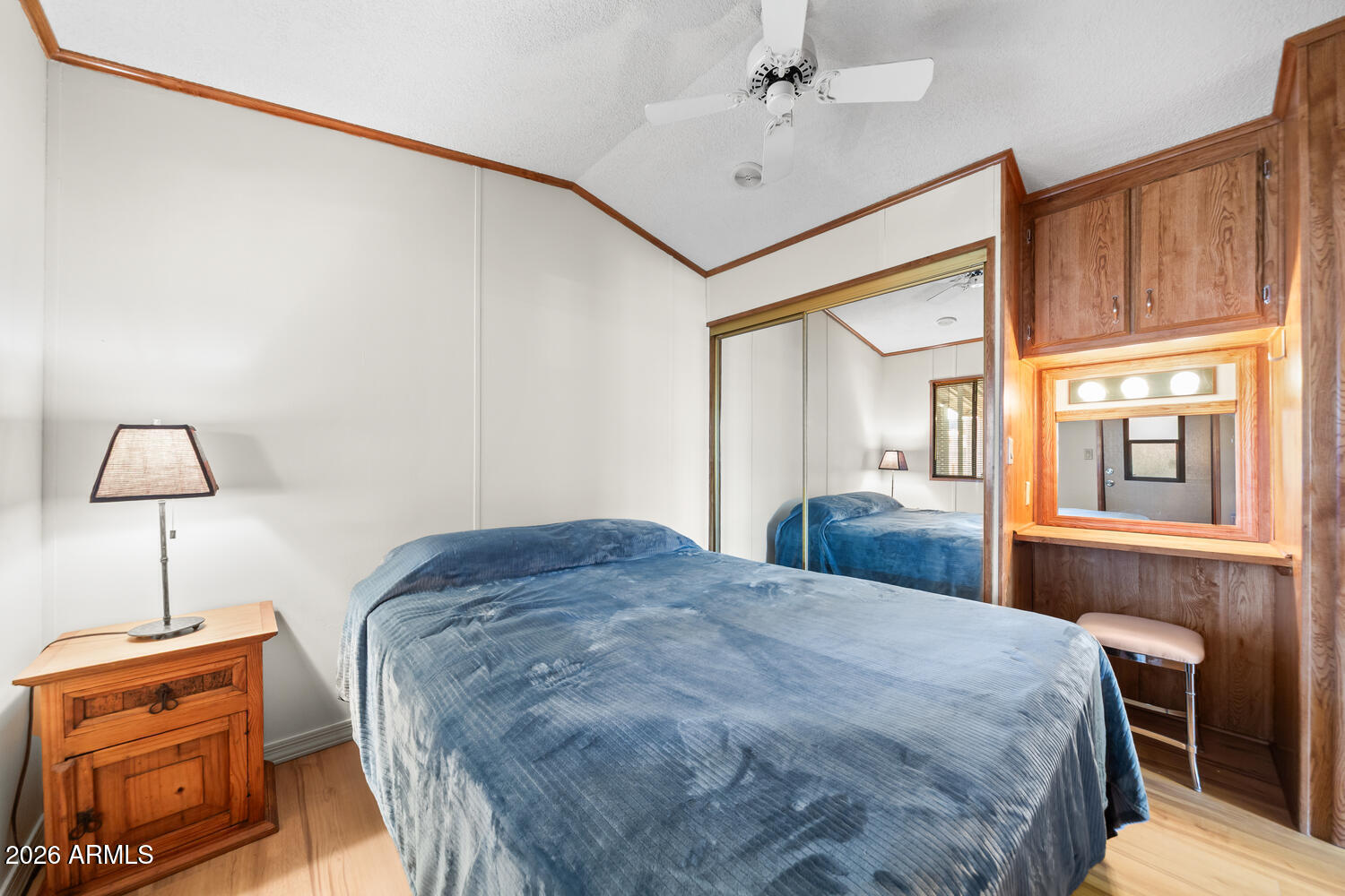 17200 West Bell Road, Unit 652 Surprise, AZ 85374 - Photo 4 of 19 a bedroom with a bed and a lamp on table