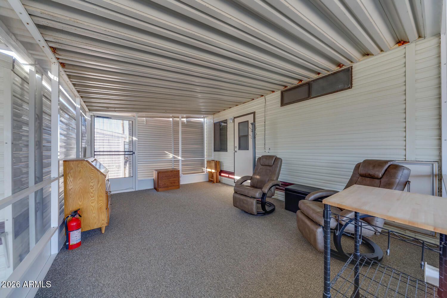17200 West Bell Road, Unit 652 Surprise, AZ 85374 - Photo 7 of 19 a view of a patio with table and chairs and a barbeque