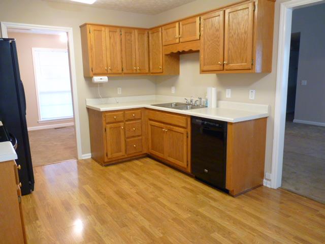 5538 Hunters Point Pike Lebanon, TN 37087 - Photo 3 of 20 a kitchen with granite countertop a sink a stove and cabinets