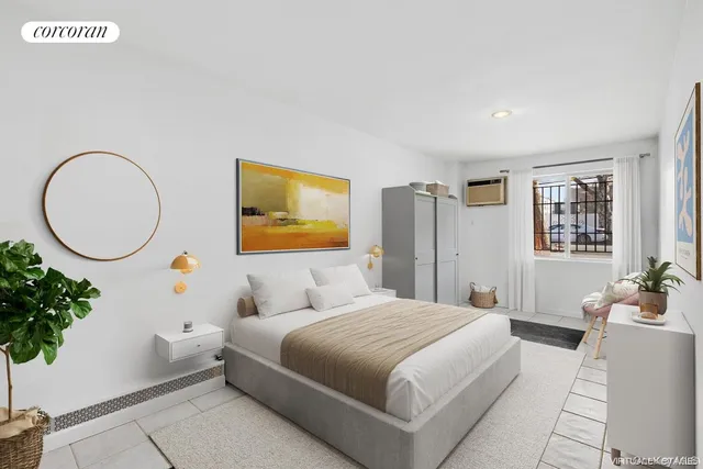 a bedroom with a large bed a potted plant and a window