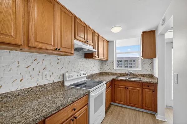 a kitchen with a sink stove and cabinets