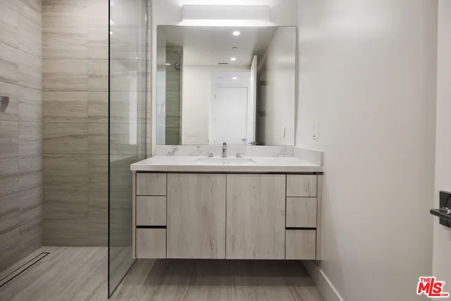 a bathroom with a sink vanity and a mirror