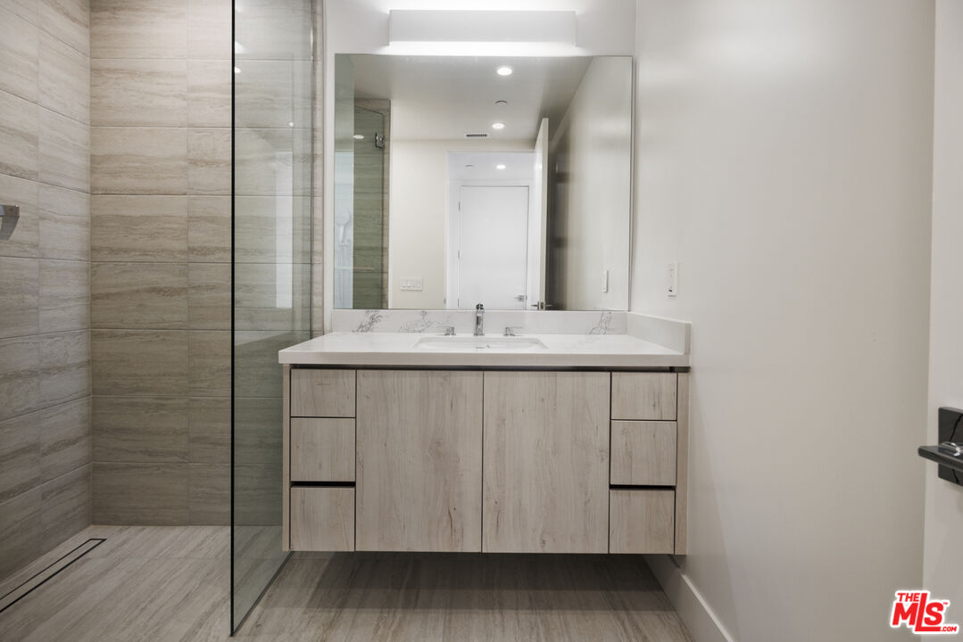 411 South Hamel Road, Unit 308 Los Angeles, CA 90048 - Photo 11 of 15 a bathroom with a sink vanity and a mirror
