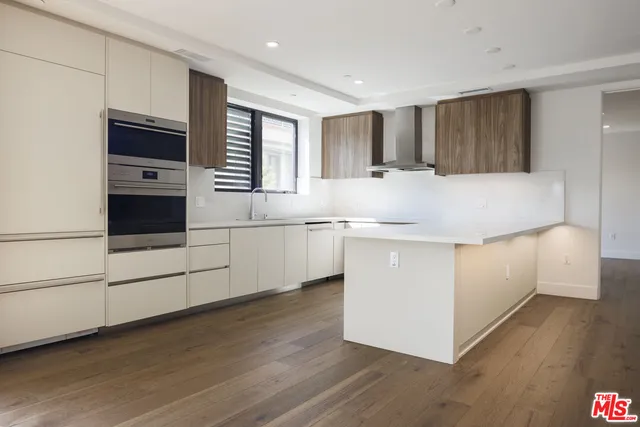 a kitchen with stainless steel appliances granite countertop a white stove top oven and a refrigerator