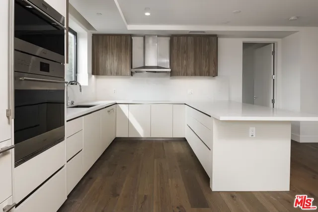 a kitchen with granite countertop stainless steel appliances and wooden cabinets