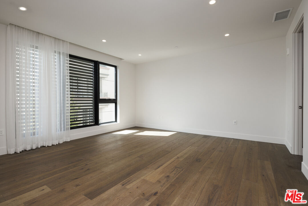 411 South Hamel Road, Unit 308 Los Angeles, CA 90048 - Photo 5 of 15 a view of an empty room with wooden floor and a window