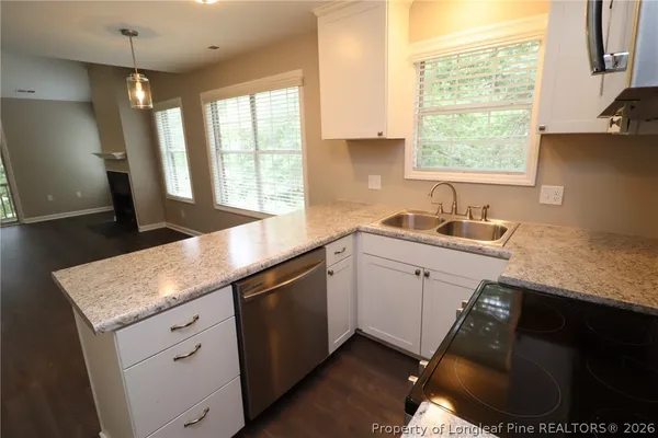 a kitchen with a sink stove and cabinets