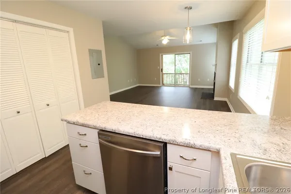 a view living room with granite countertop cabinets and wooden floor