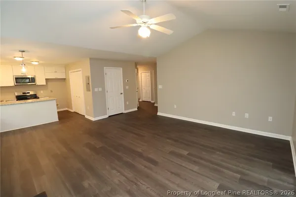 a view of a kitchen with a sink and a refrigerator