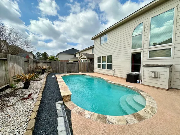 a swimming pool with outdoor seating yard and barbeque oven