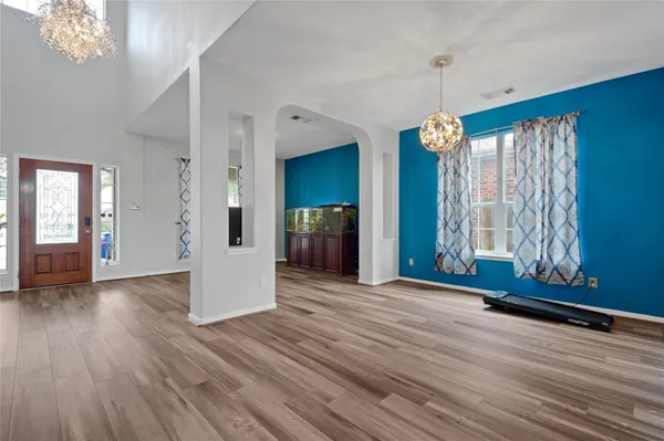 a view of a hallway view with wooden floor and staircase