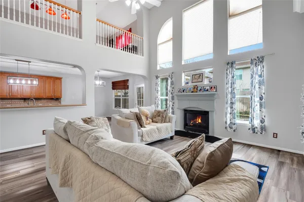 a living room with stainless steel appliances kitchen island granite countertop furniture and a fireplace