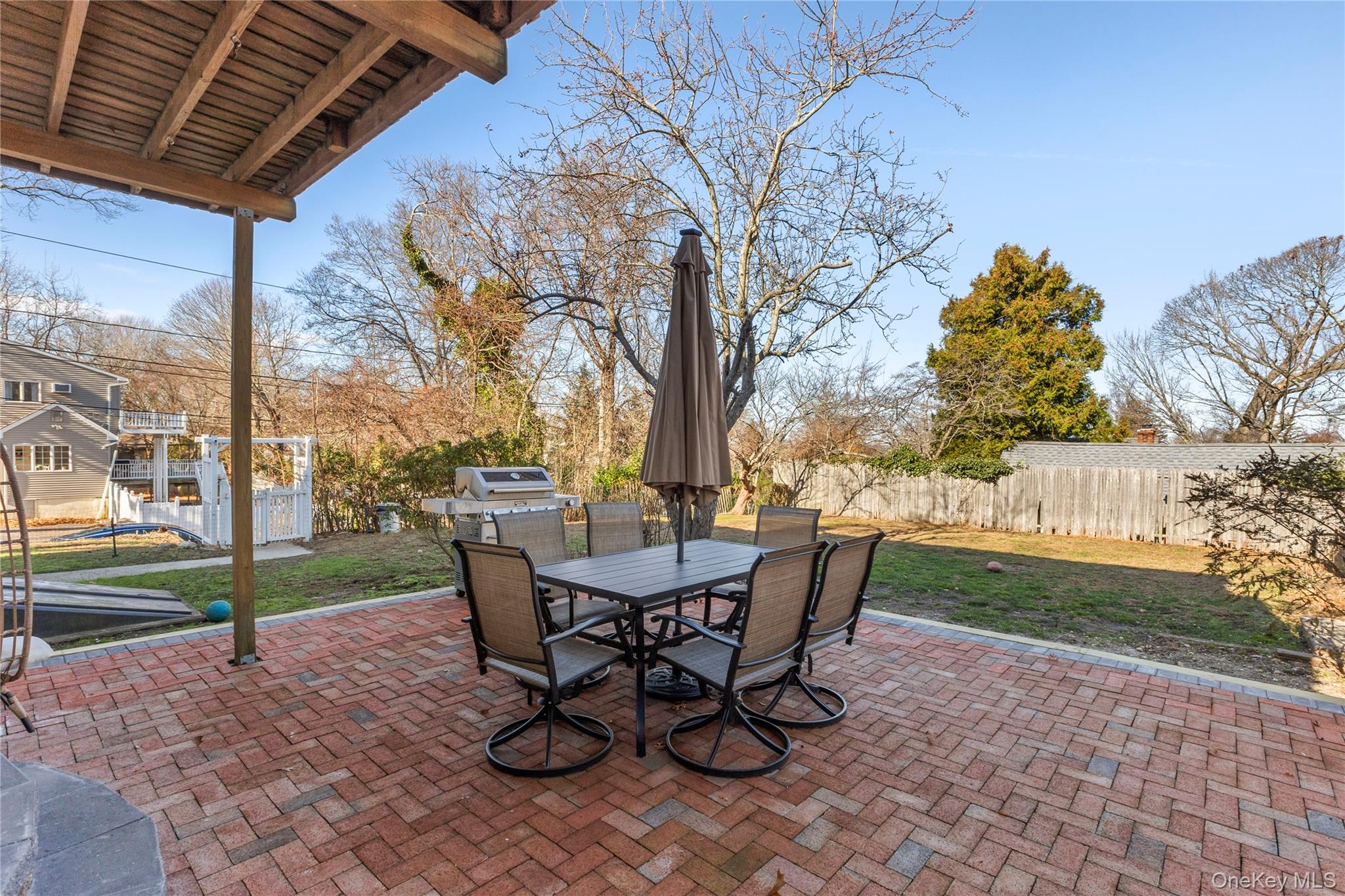 1 Tarn Road Rocky Point, NY 11778 - Photo 19 of 25 a view of a patio with table and chairs and potted plants