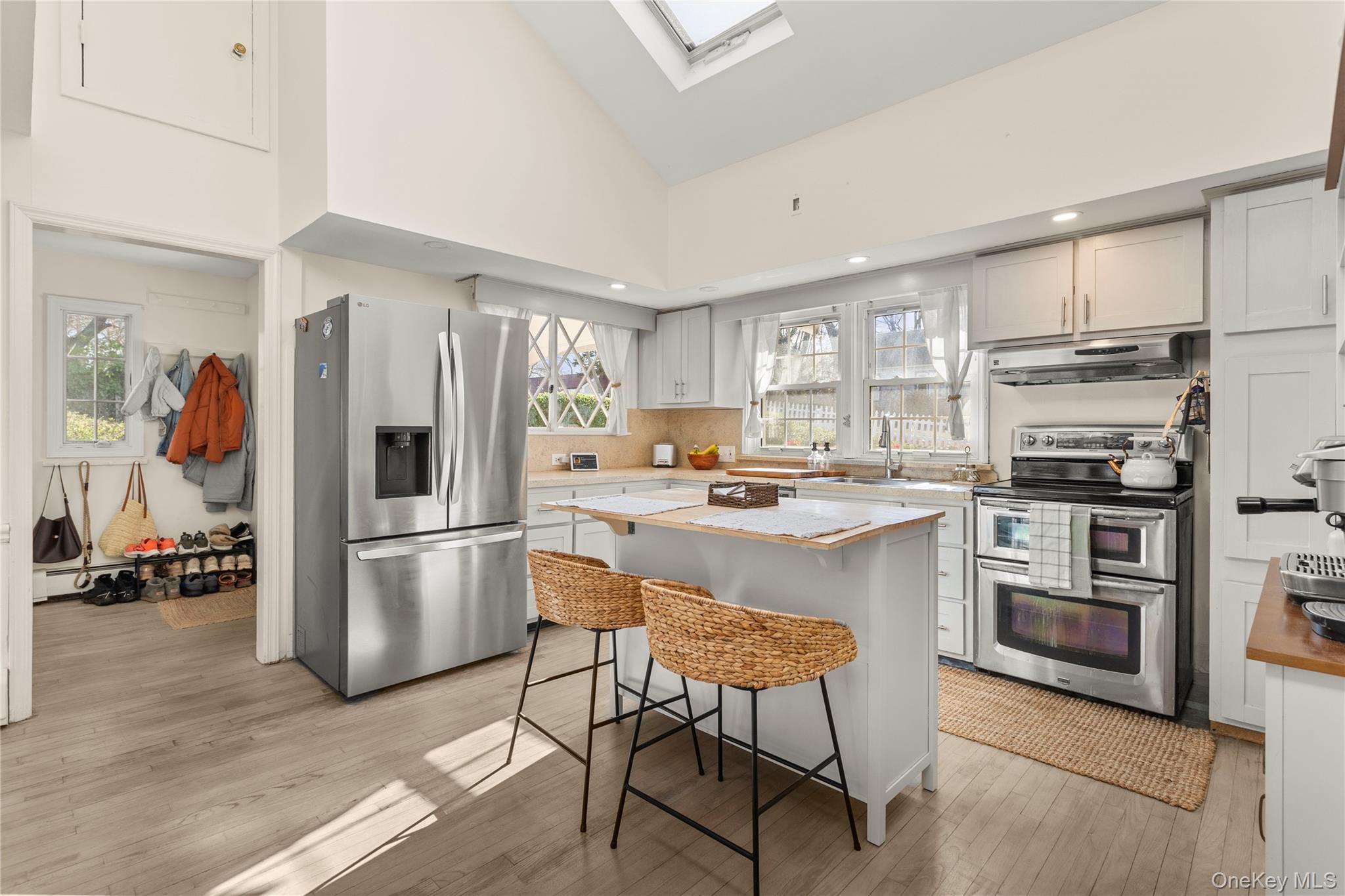 1 Tarn Road Rocky Point, NY 11778 - Photo 6 of 25 a kitchen with kitchen island white cabinets and stainless steel appliances