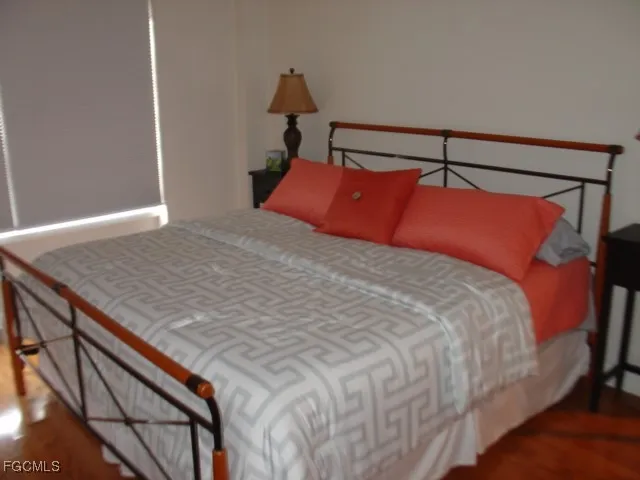 a bed sitting in a bedroom next to a window