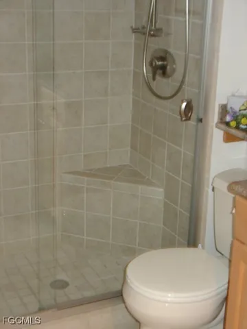 a bathroom with a toilet and a shower