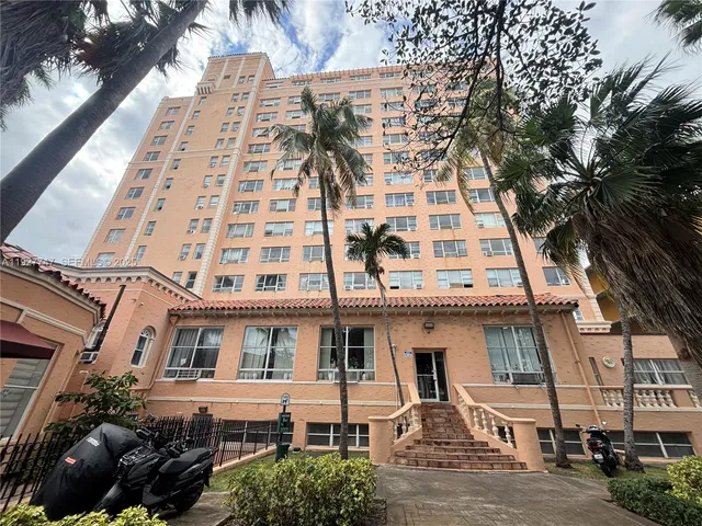 a view of a kitchen with wooden floor and electronic appliances