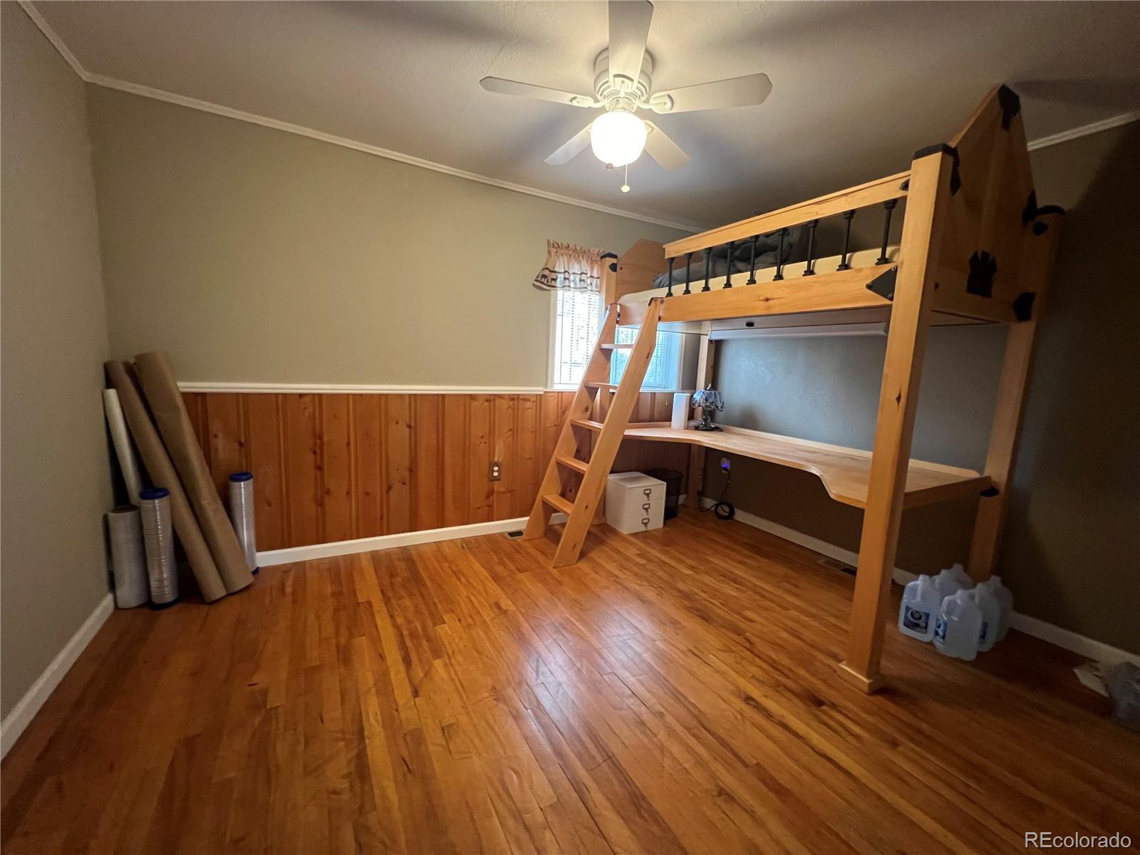 187 Johnson Road Bailey, CO 80421 - Photo 12 of 37 a view of an empty room with wooden floor and furniture