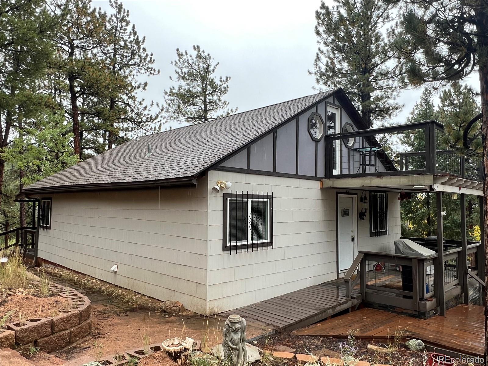 187 Johnson Road Bailey, CO 80421 - Photo 2 of 37 a front view of a house with sitting area