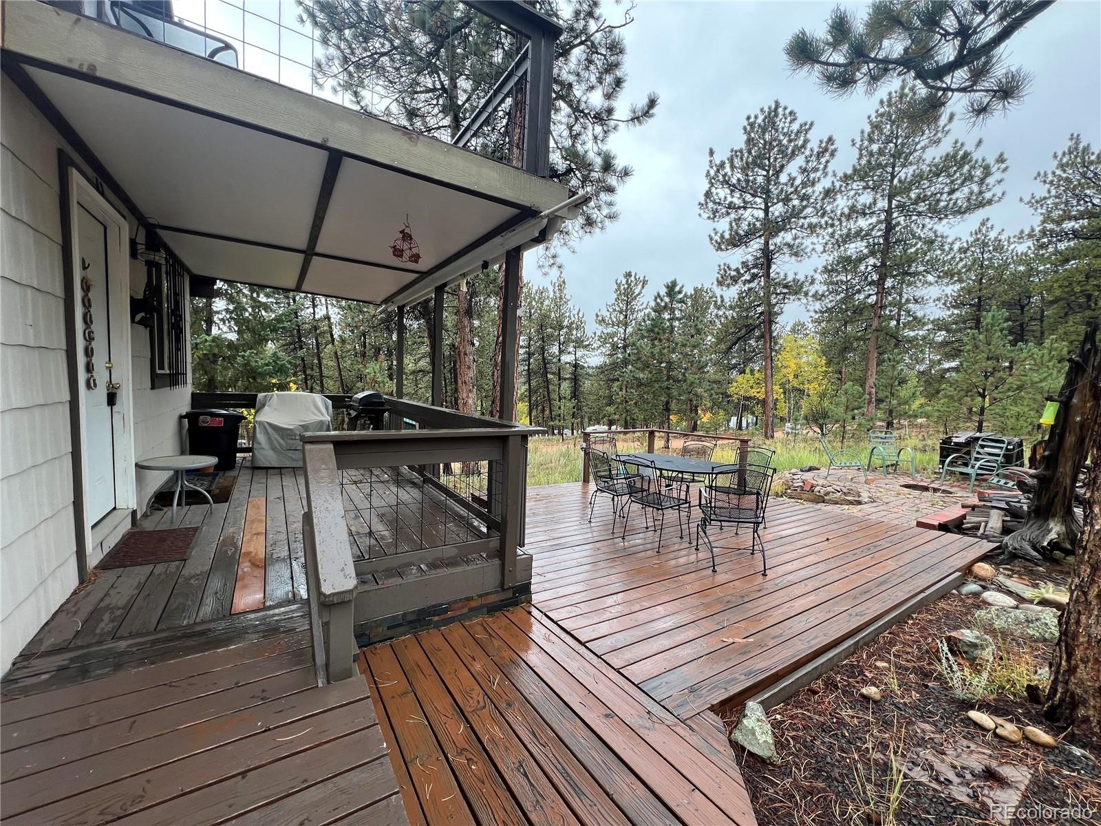 187 Johnson Road Bailey, CO 80421 - Photo 22 of 37 a view of outdoor seating space with wooden floor