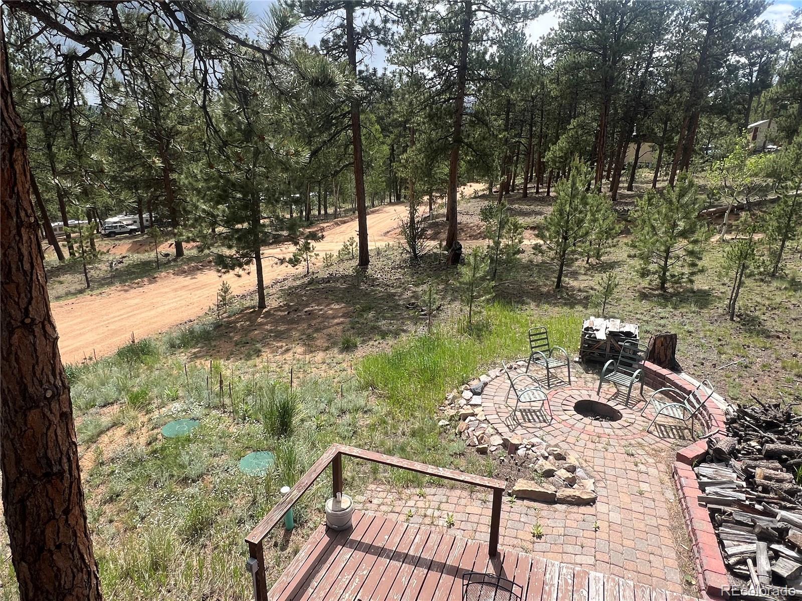 187 Johnson Road Bailey, CO 80421 - Photo 24 of 37 a view of a yard with chairs