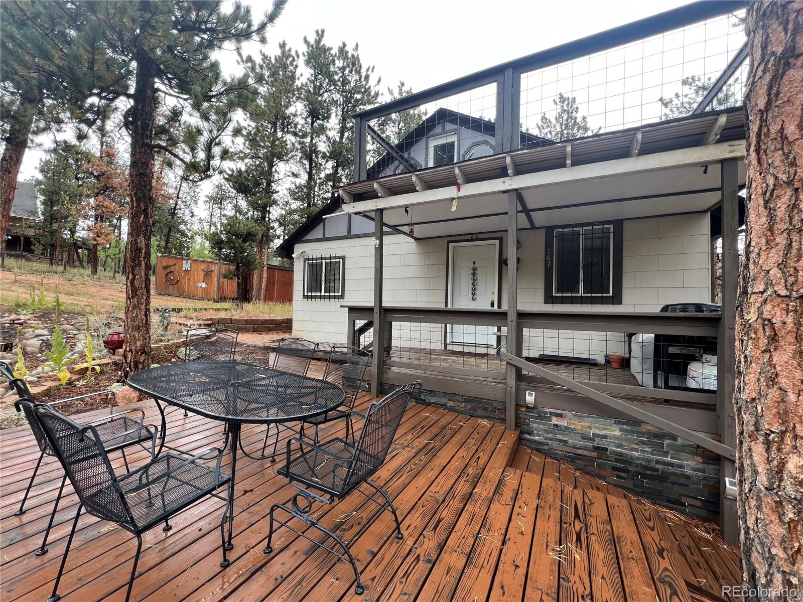 187 Johnson Road Bailey, CO 80421 - Photo 3 of 37 a view of a house with backyard and sitting area