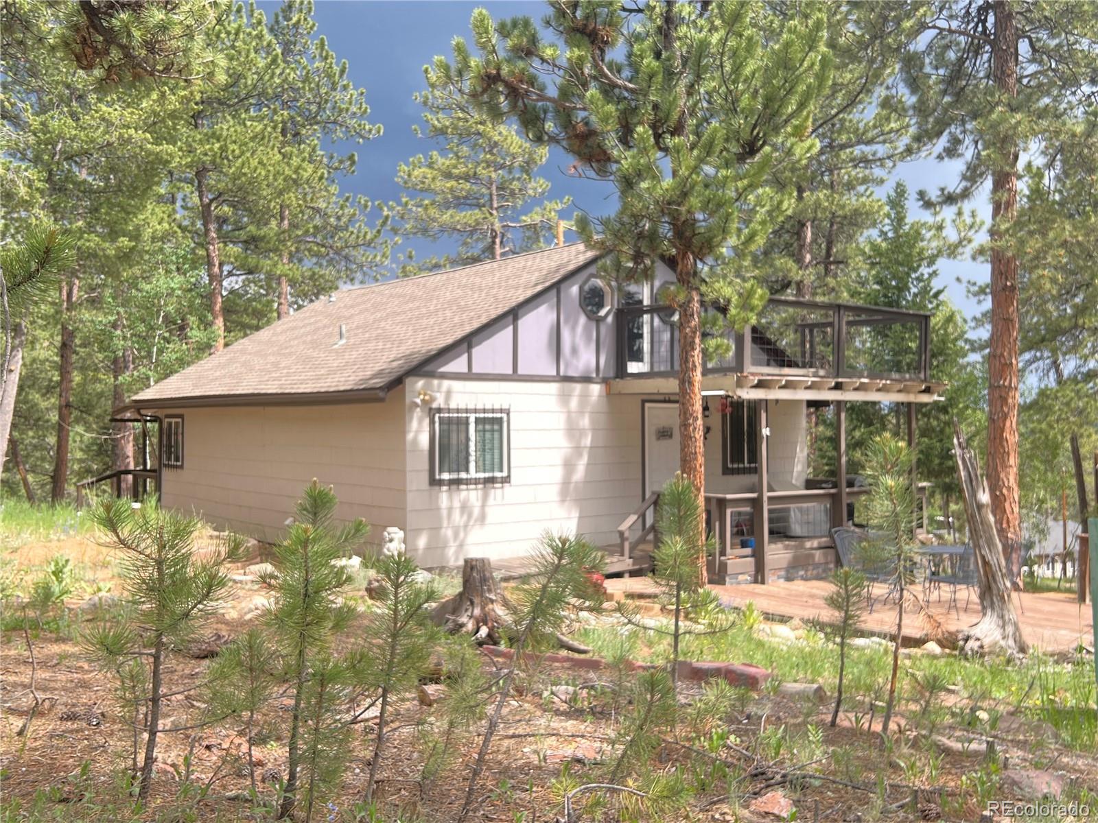 187 Johnson Road Bailey, CO 80421 - Photo 37 of 37 a backyard of a house with table and chairs