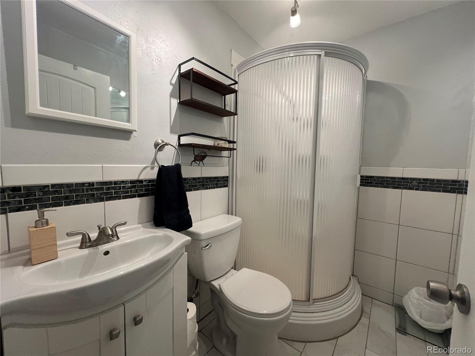 187 Johnson Road Bailey, CO 80421 - Photo 10 of 37 a bathroom with a sink toilet and shower