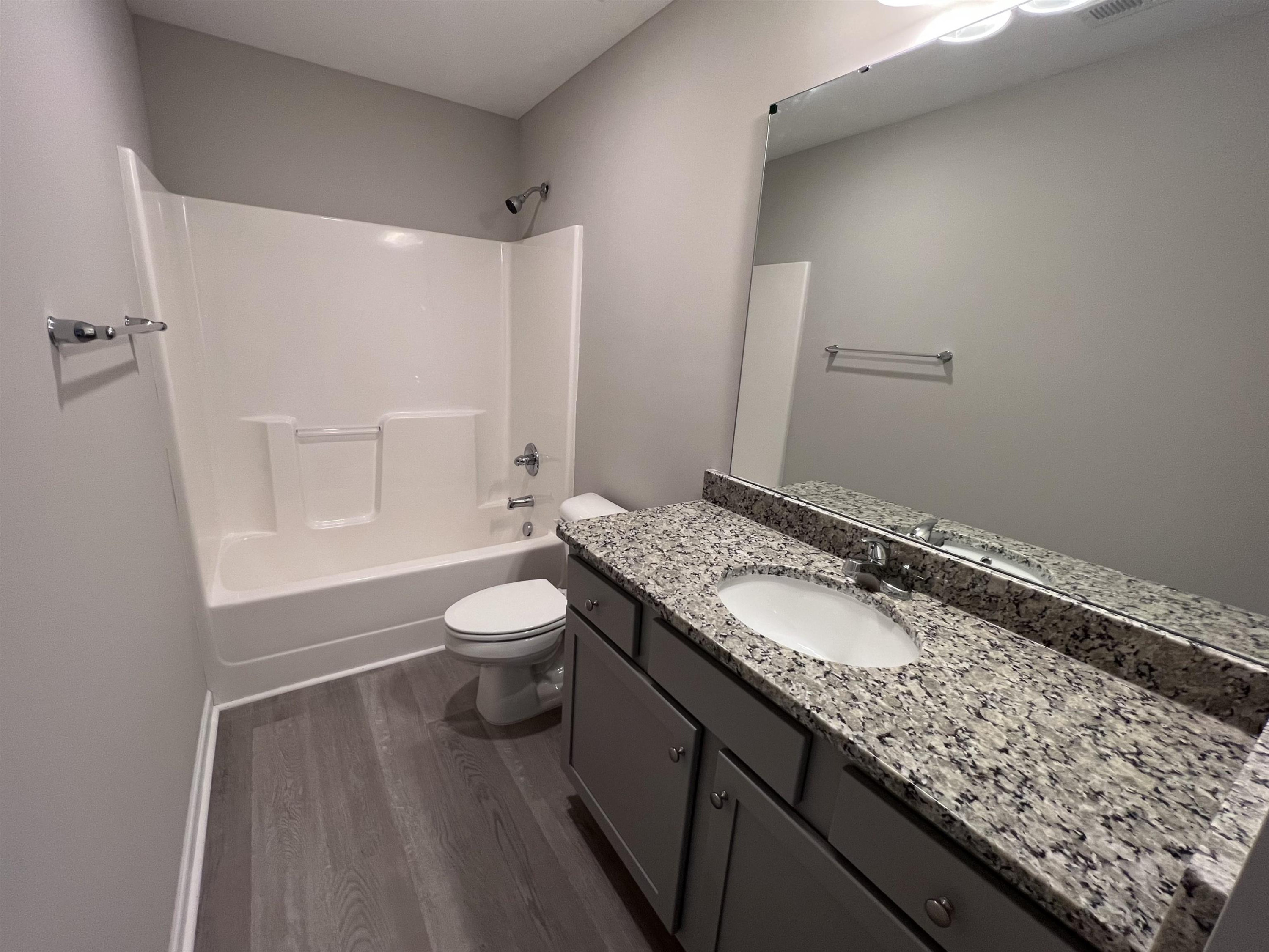 346 Touchdown Way Benson, NC 27504 - Photo 13 of 16 a bathroom with a granite countertop sink toilet and shower