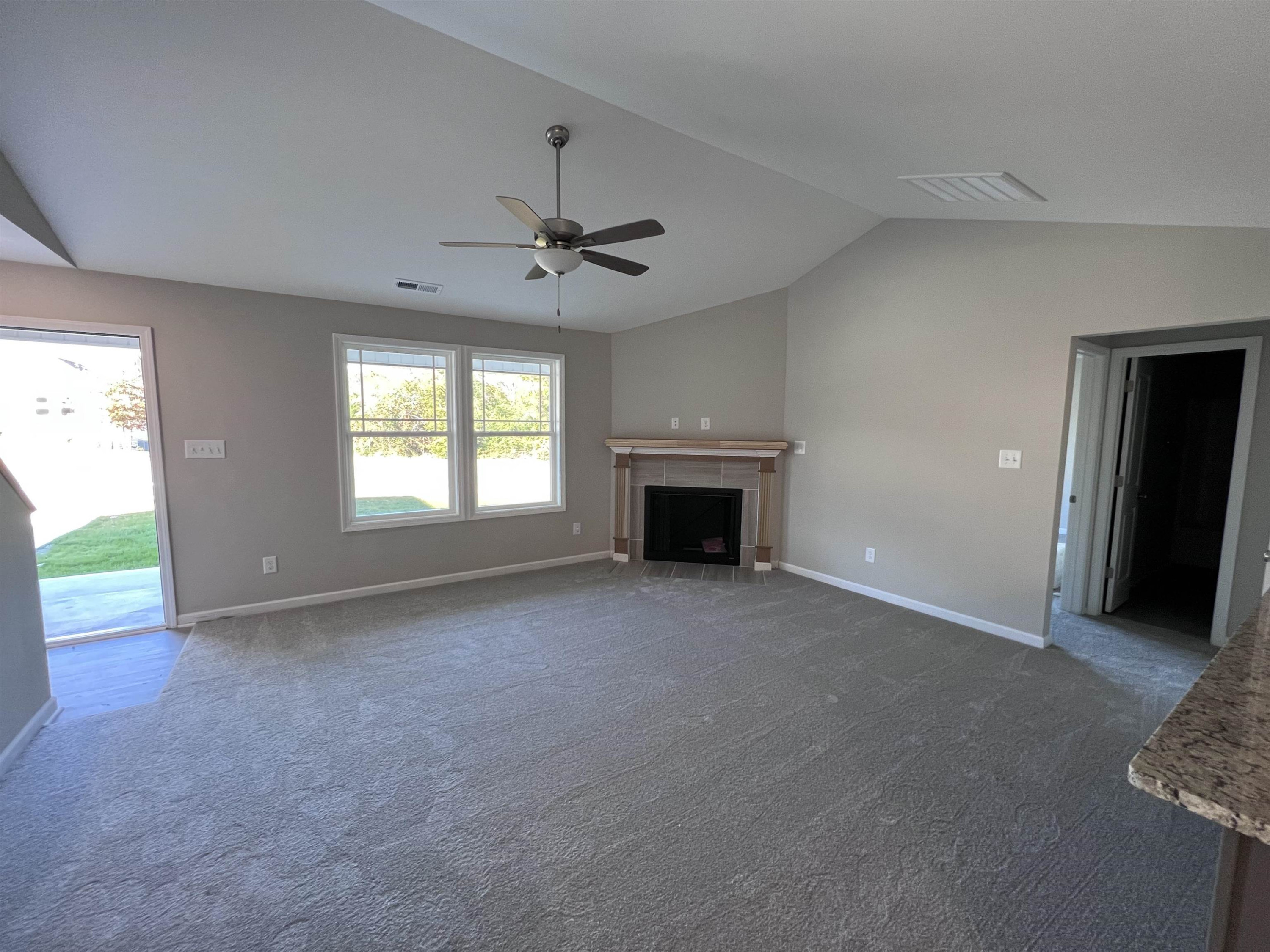 346 Touchdown Way Benson, NC 27504 - Photo 3 of 16 a view of empty room with a fireplace and fan