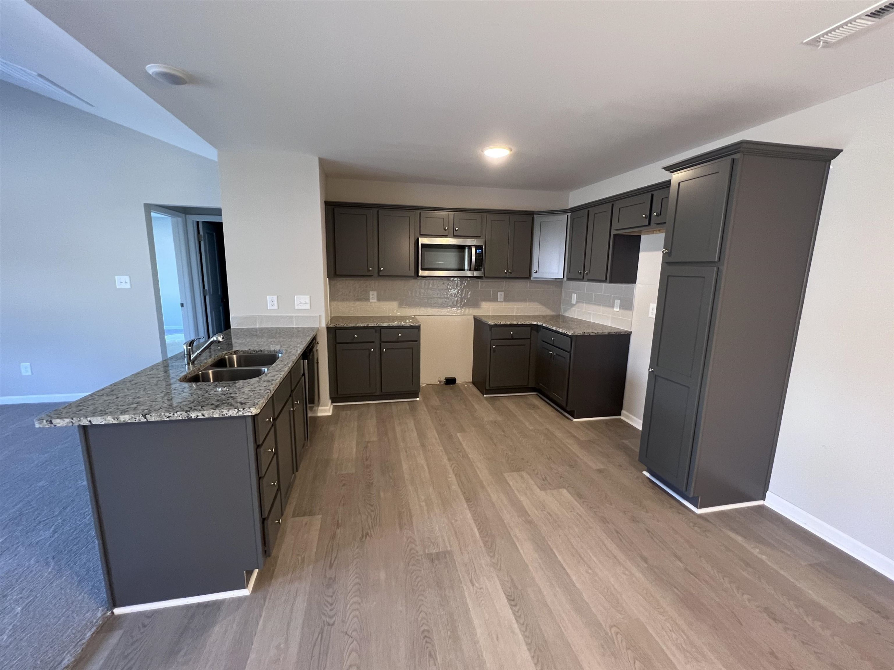 346 Touchdown Way Benson, NC 27504 - Photo 6 of 16 a kitchen with stainless steel appliances granite countertop a refrigerator stove and sink