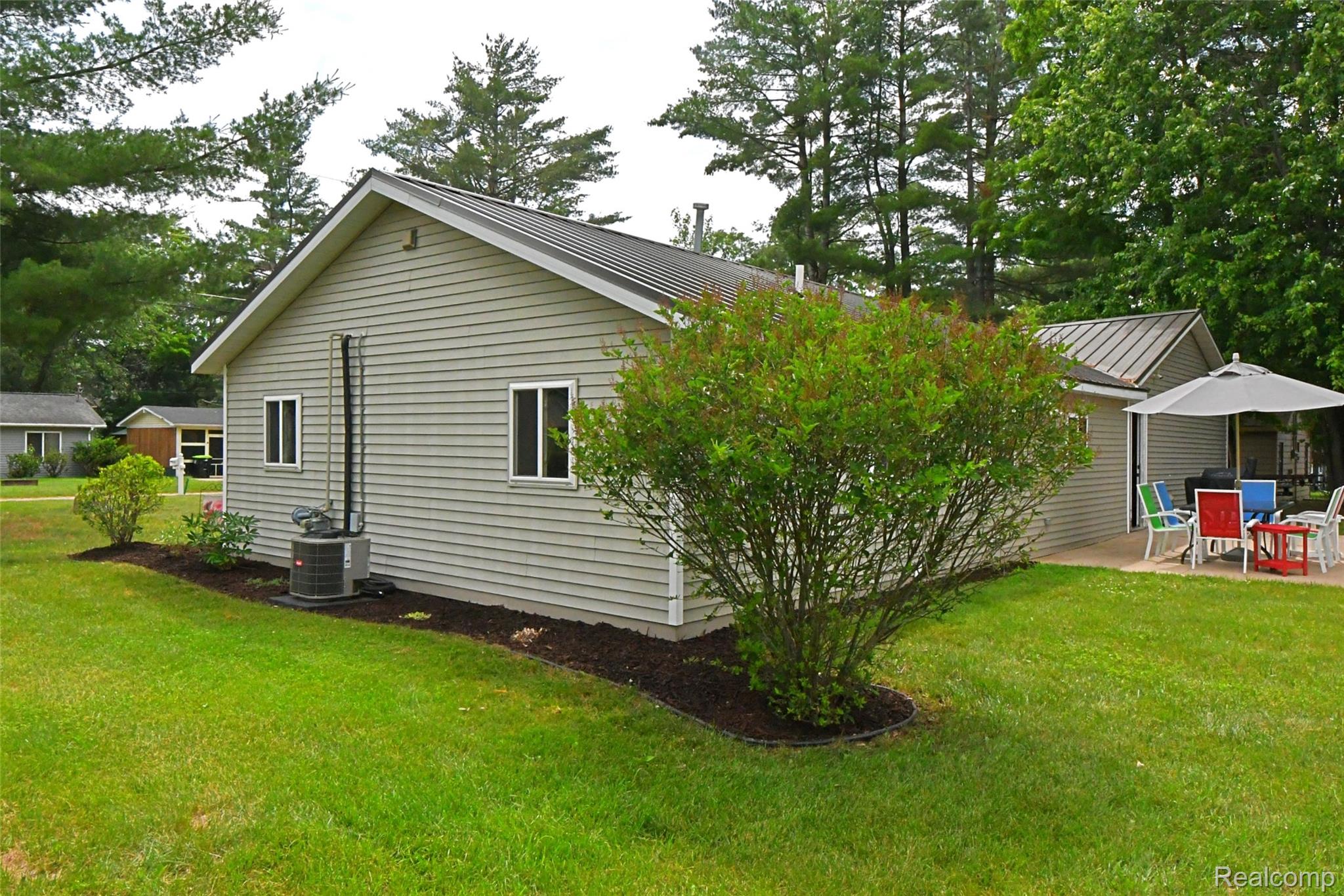 9611 Monroe Road St. Helen, MI 48656 - Photo 22 of 24 Light gray siding exterior with a dark metal roof
