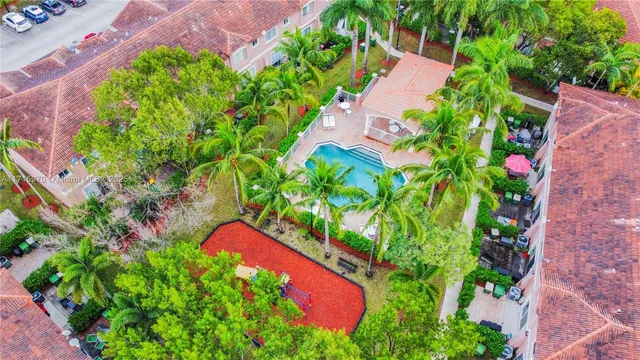 an aerial view of lake and residential houses with outdoor space