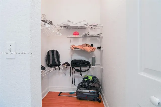 a multi story building with trees in front of it