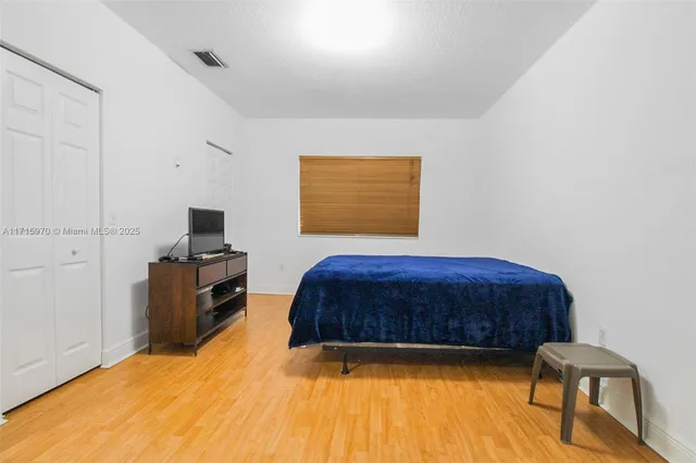a bedroom with a bed and a television