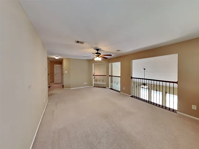 a view of a livingroom with a ceiling fan and window