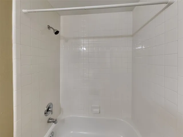 a bathroom with a shower and a bath tub
