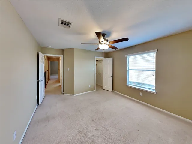 a view of a livingroom with a ceiling fan and window